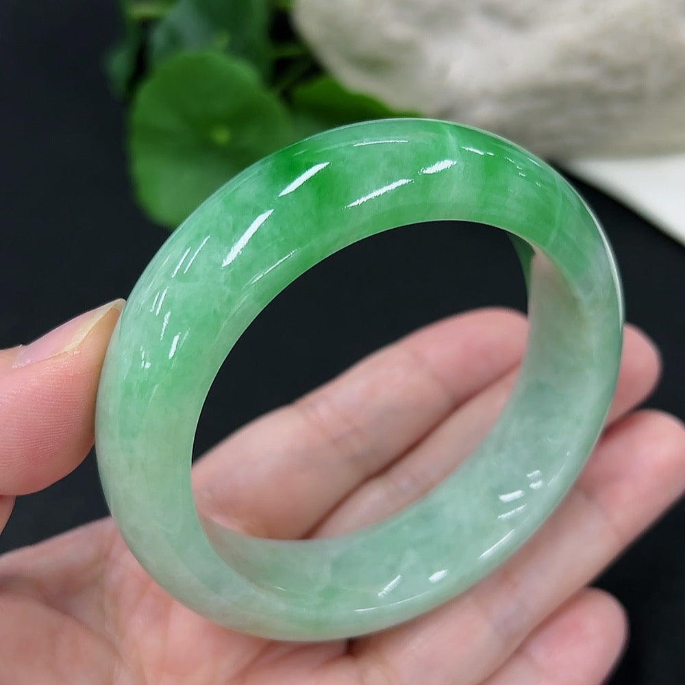 Jadeite round bangle with a size of 53.6, weighing approximately 82 grams, featuring smooth, polished jadeite from HKHQ.