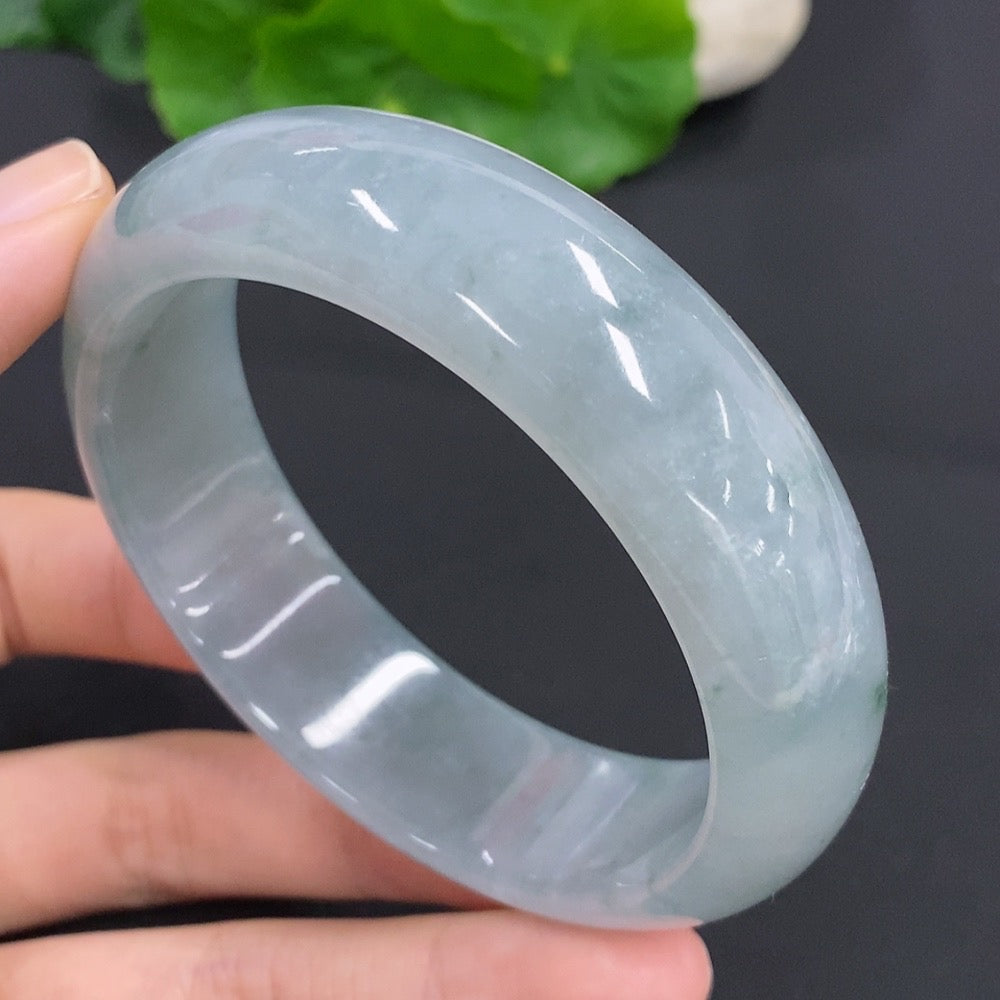 Handcrafted jadeite bangle from HKHQ featuring smooth, polished jade with a vibrant green hue, showcasing elegant jewelry craftsmanship.