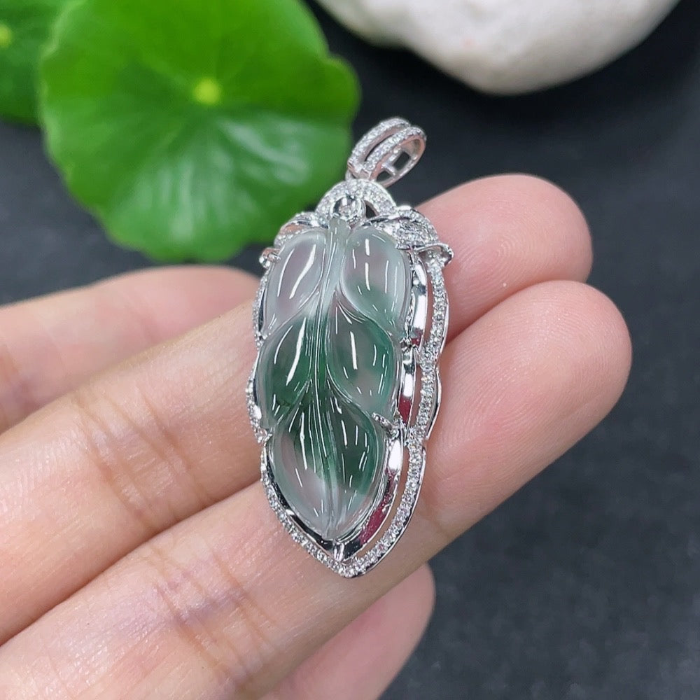 Jadeite leaf pendant with 18K gold accents and diamond details, showcasing a delicate design with a total weight of about 5g.