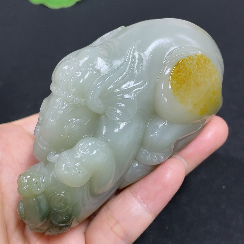 Hetian jade seed material hand piece by HKHQ featuring smooth jade surface and intricate craftsmanship.