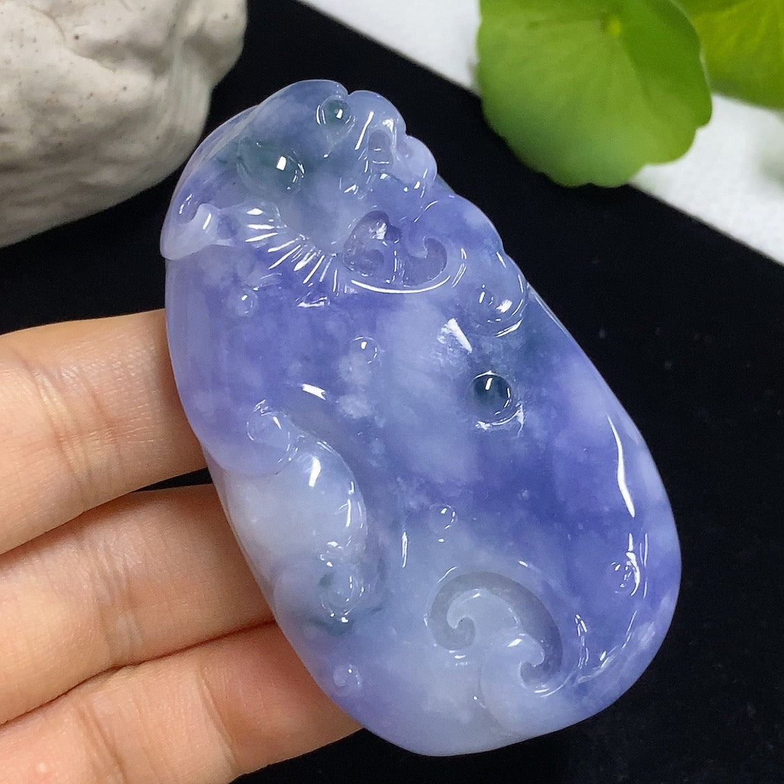 Jadeite Ruyi pendant with intricate carvings, weighing approximately 60.49g, showcasing smooth, polished jade from HKHQ.