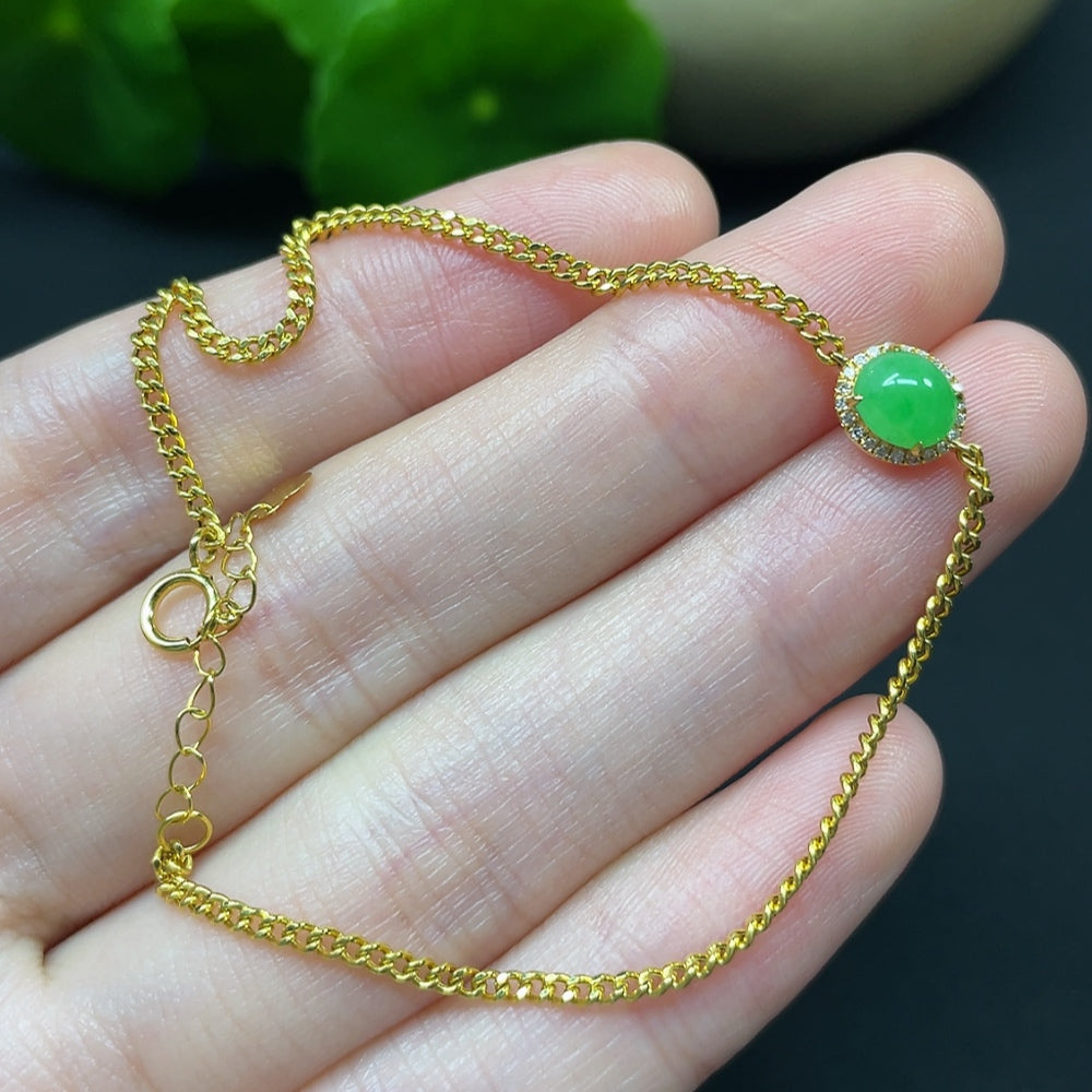 Jadeite cabochon bracelet in 18K gold with diamond accents, featuring a sleek, elegant jewelry design.