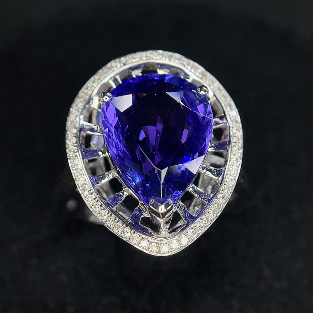 18K gold Tanzanite ring with diamond accents, size 11, featuring vibrant blue gemstones and sparkling diamond details.
