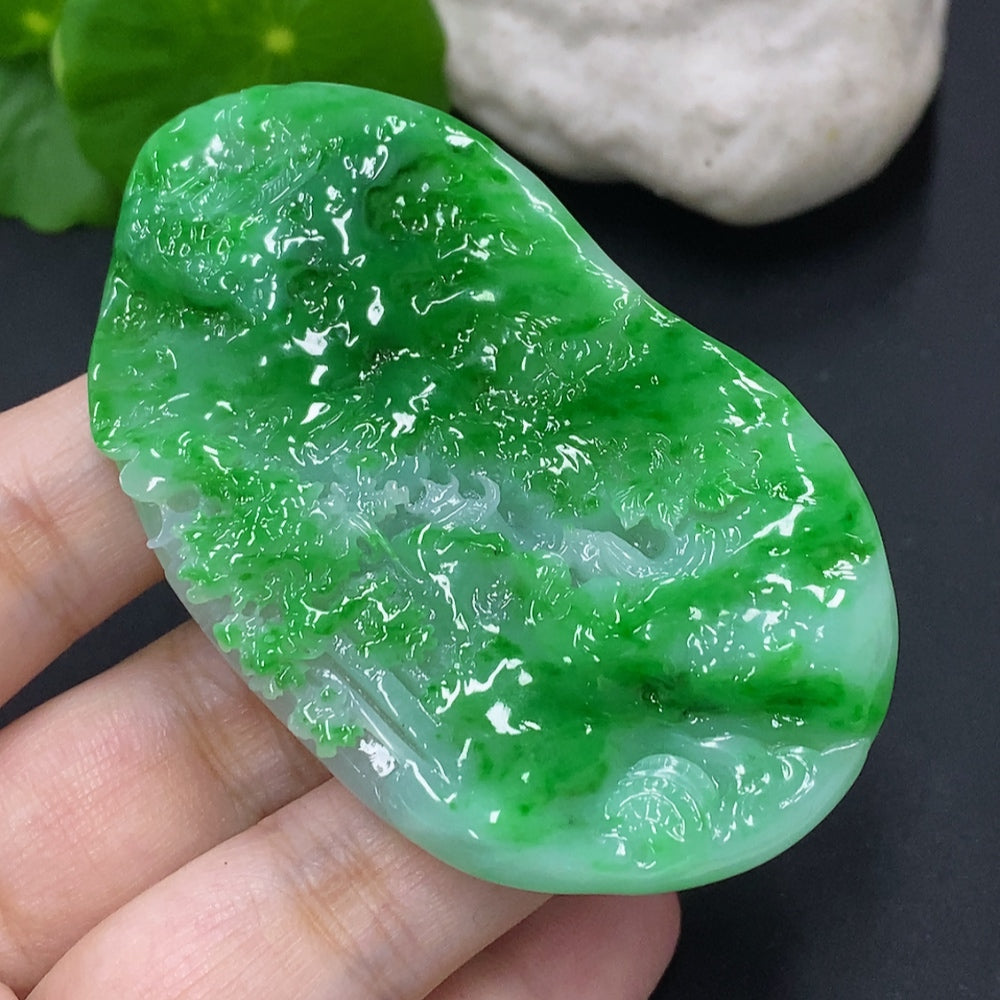 Jadeite landscape pendant by HKHQ featuring detailed green jade carving, weighs approximately 65.3 grams.