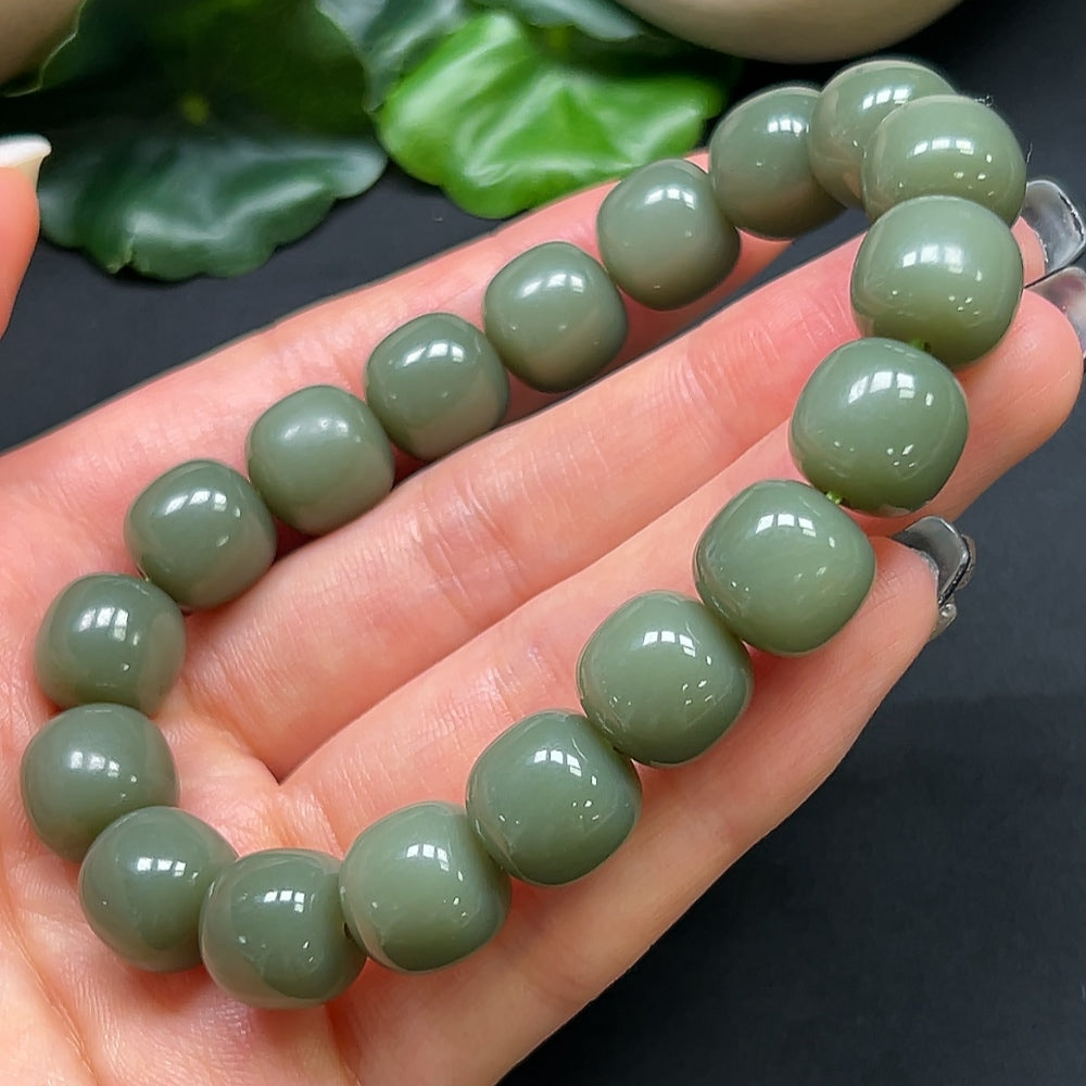 HKHQ Hetian Jade bracelet with 11.8mm beads, approximately 49.28g, showcasing smooth, polished jade stones on a delicate string.