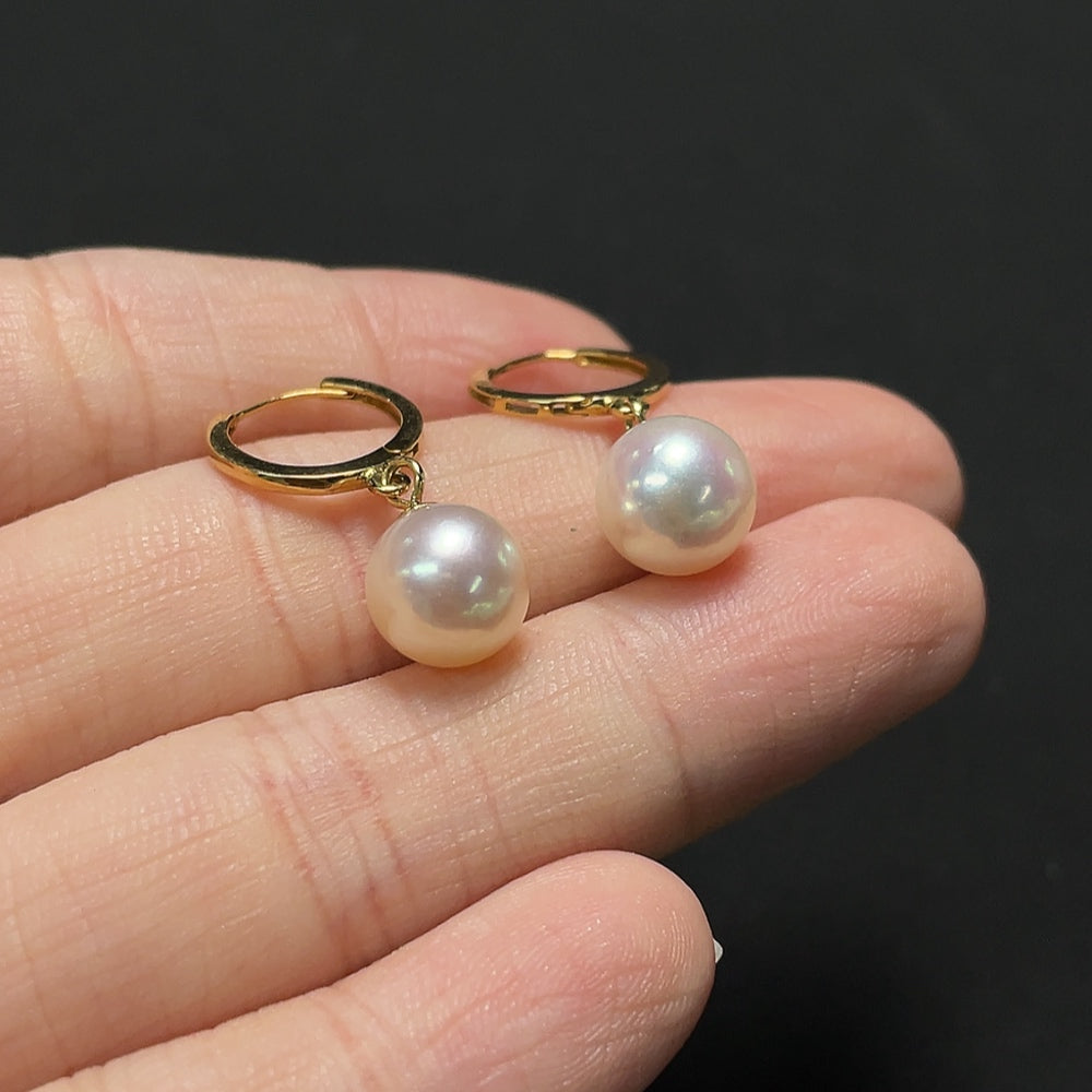 Saltwater pearl earrings with 18K gold setting from HKHQ, showcasing elegant pearl drops on a delicate earring design.