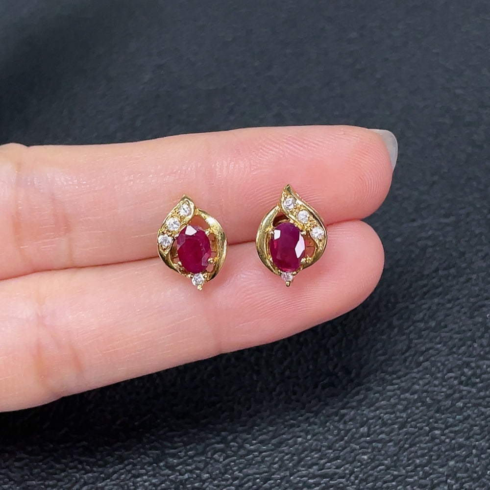 Ruby gemstone stud earrings with 18K gold and platinum silver caps, accented with small diamonds, weighing approximately 1.52g.