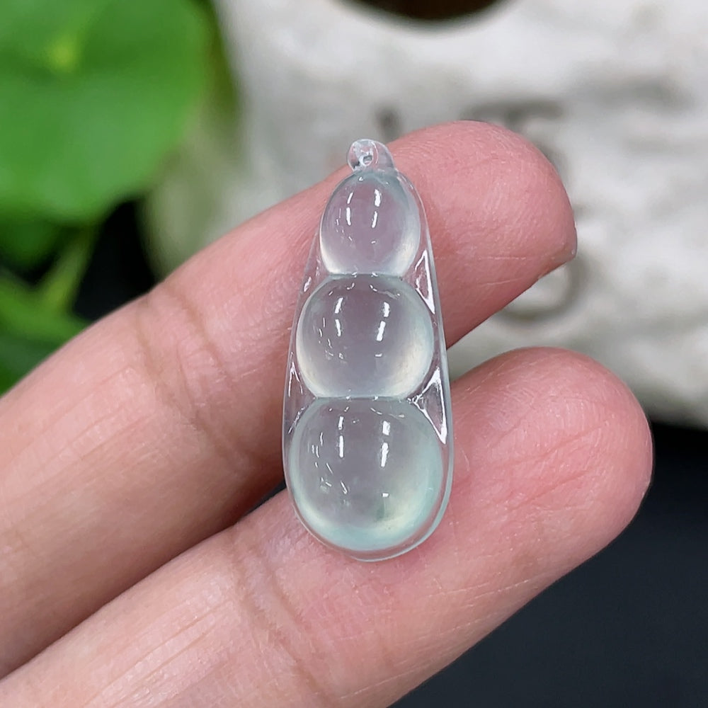 Jadeite auspicious bean inlay piece by HKHQ, detailed view showing smooth green jade surface and intricate craftsmanship.