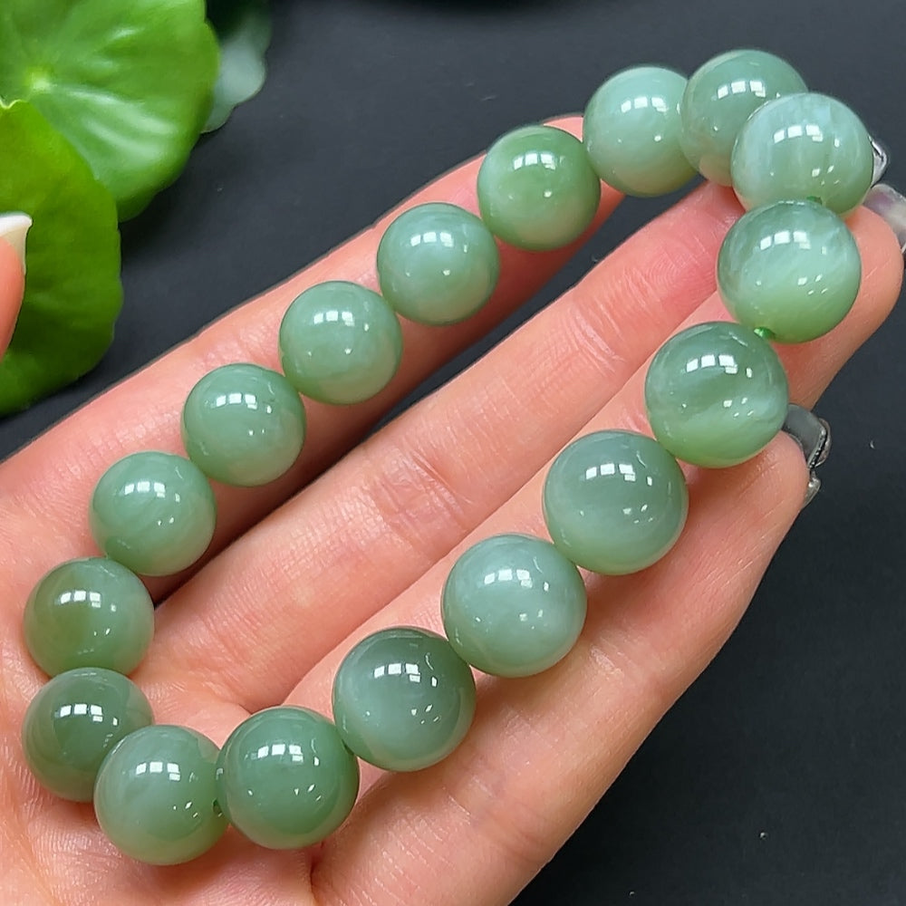 Hetian Jade bracelet with 11.8mm beads, weighing approximately 44.38g, featuring smooth, polished jade stones from HKHQ.