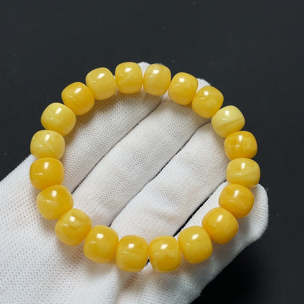 Amber beeswax bracelet with 10.6mm beads, weighing approximately 14.44g, featuring warm amber tones and a smooth finish.
