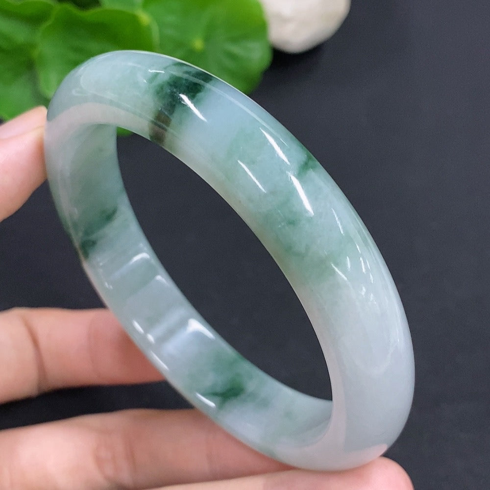 HKHQ jadeite round bangle, 65.6g, size 60, smooth green jade jewelry, detailed close-up of the polished surface.