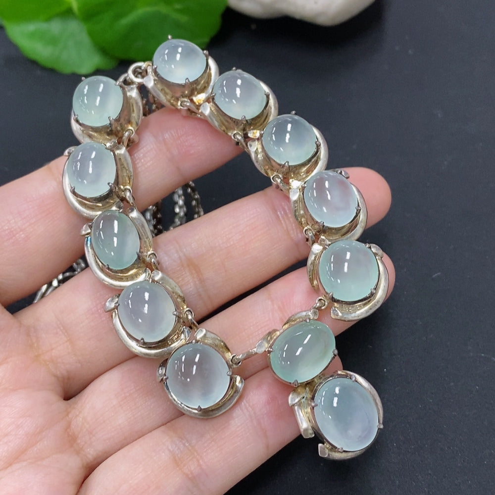 Jadeite cabochon gemstone with non-gold setting, weighs approximately 61.2 grams, featuring smooth polished surface and vibrant green color.