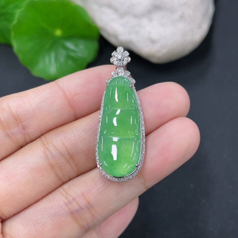 Jadeite lucky bean pendant with 18K gold and diamond accents, featuring intricate inlaid jade design and a polished finish.