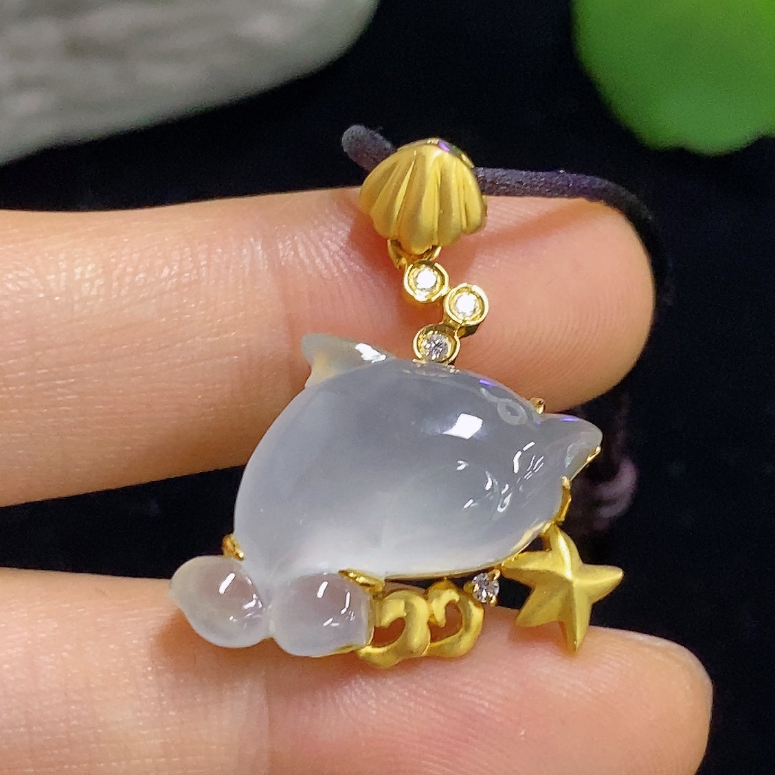 Jadeite inlaid pendant with 18K gold and diamond accents, featuring a rope chain, weighing approximately 7.1 grams.