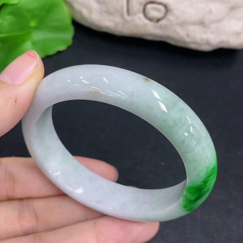 Elegant jadeite oval bracelet featuring polished green jade stones, crafted by HKHQ, displayed on a neutral background.