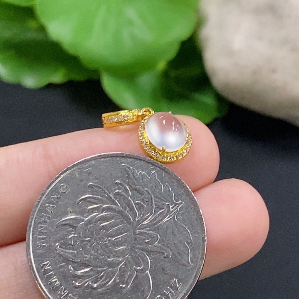Jadeite cabochon pendant necklace with 18K gold and diamond accents, featuring a smooth green gemstone and delicate gold setting.