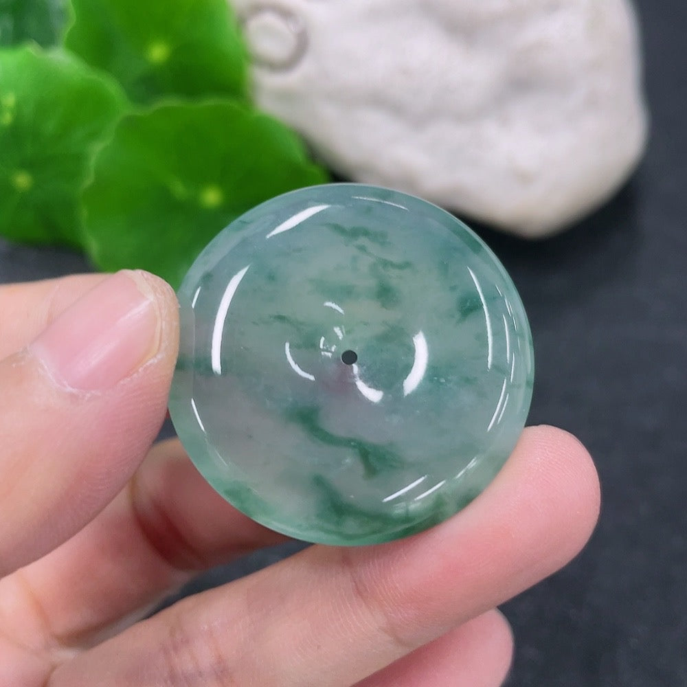 Jadeite pendant with peace knot design, approximately 11.18g, crafted by HKHQ, showcasing smooth green jade carving.