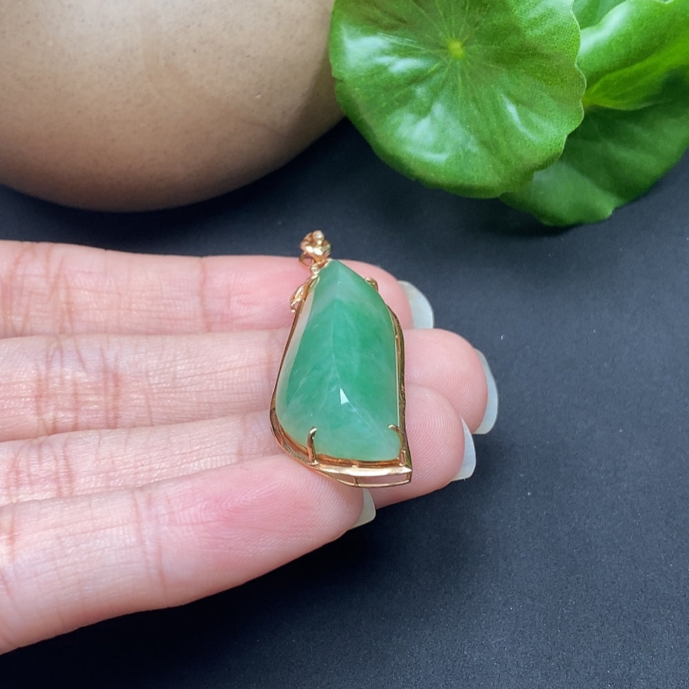 Jadeite inlaid pendant with diamond accents on an 18K necklace, featuring a polished green jadeite gemstone and sparkling diamond details.
