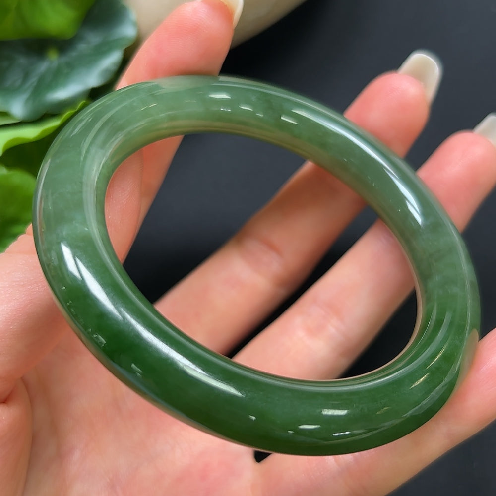 Hetian jade round bangle bracelet by HKHQ, size 55.4 with a smooth polished surface and natural jade color.