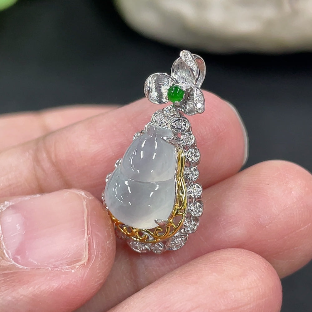 Jadeite gourd pendant with 18K gold and diamond accents, displayed on a necklace chain, showcasing elegant jewelry craftsmanship.