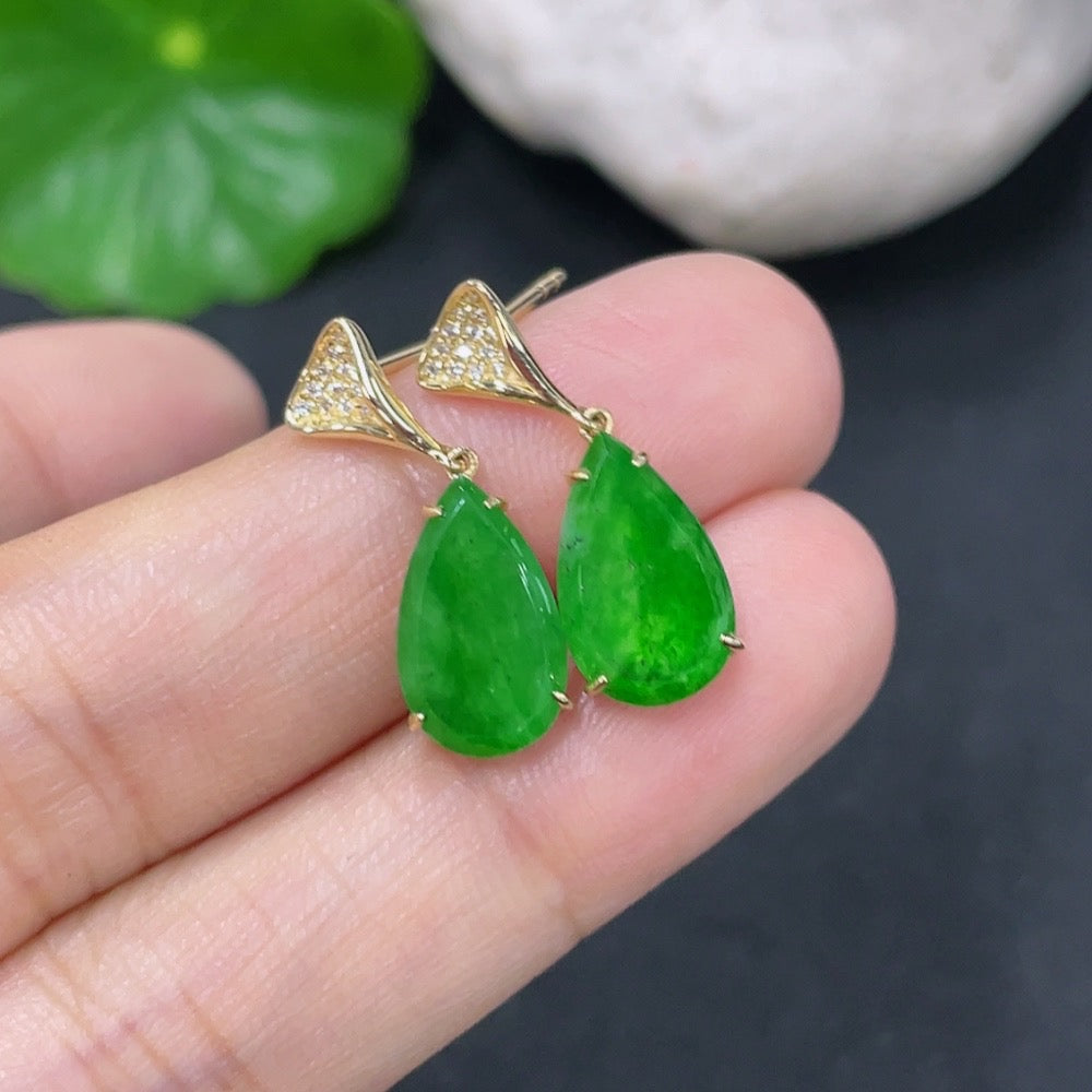 Jadeite earrings with 18k gold and diamond accents, showcasing polished green jade stones and intricate jewelry design.