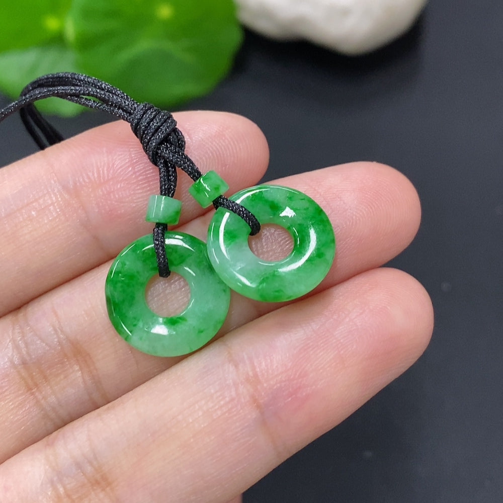 Six jadeite donut pendants for necklaces, totaling approximately 2.3g, displayed together with polished green jade appearance.
