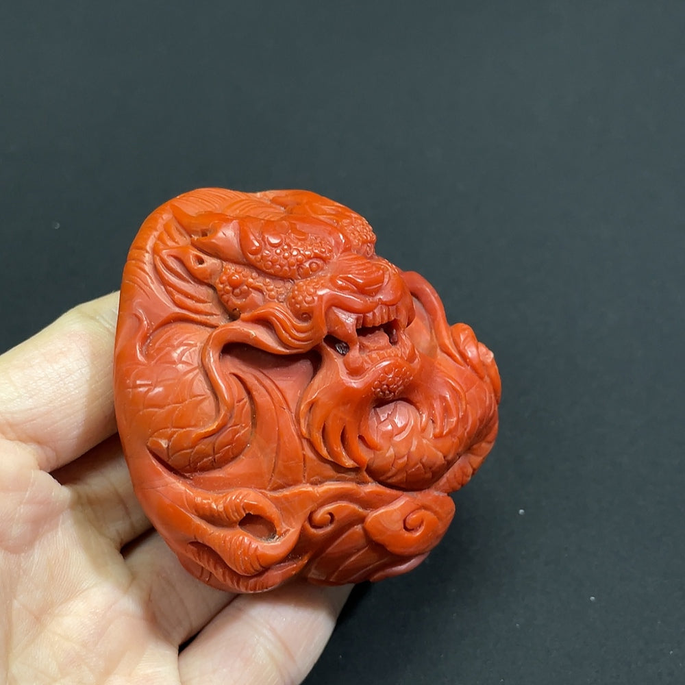 South Red Agate gemstone pendant with visible organic matter, showcasing natural textures and rich red hues, weighs approximately 132.3g.
