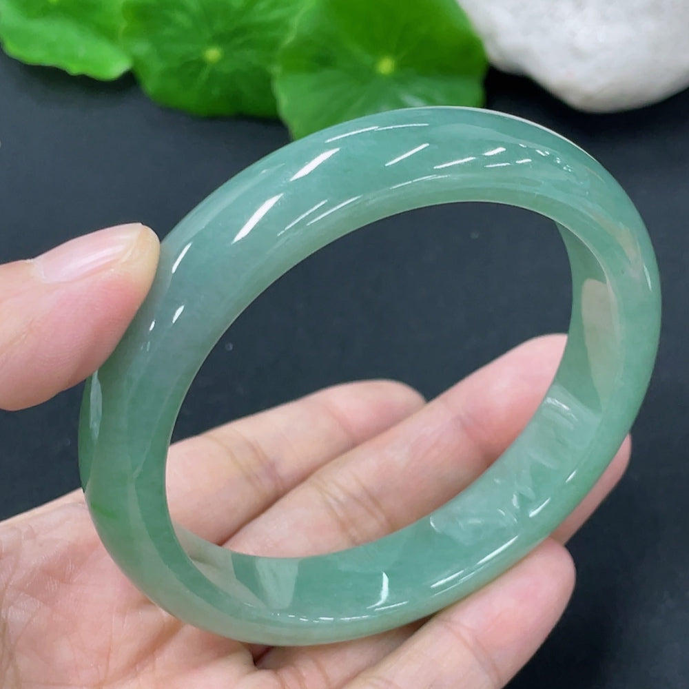 HKHQ jadeite round bangle, approximately 54.38g, size 56.9, showcasing smooth, polished green jadeite with a glossy finish.