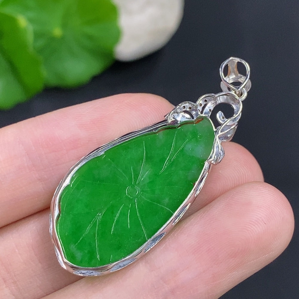 Jadeite lotus leaf pendant with 18K gold accents and diamond details, showcasing intricate craftsmanship and elegant design.