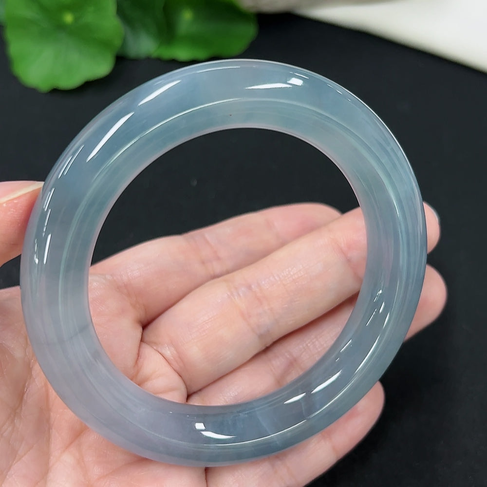 HKHQ jadeite round bangle, size 55.2, weighing 71.6g, showcasing smooth, polished jadeite bracelet on a plain background.