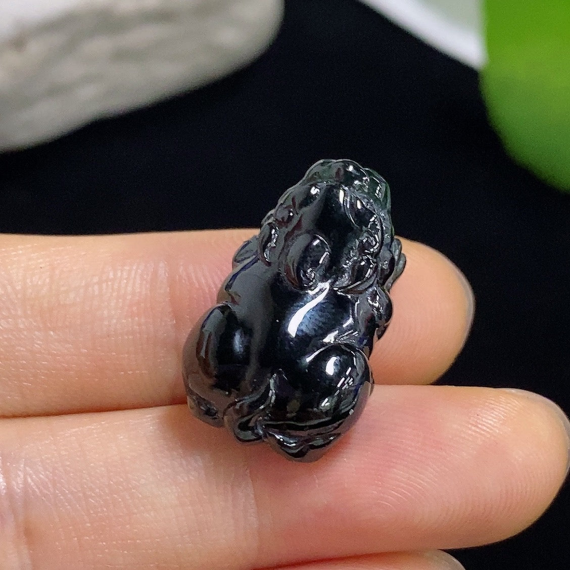 Jadeite Pi Xiu pendant in vibrant green jade, featuring intricate carvings, crafted by HKHQ for good luck and protection.