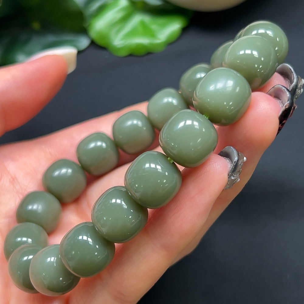 HKHQ Hetian Jade bracelet with 11.8mm beads, showcasing smooth, polished jade stones in a close-up view.