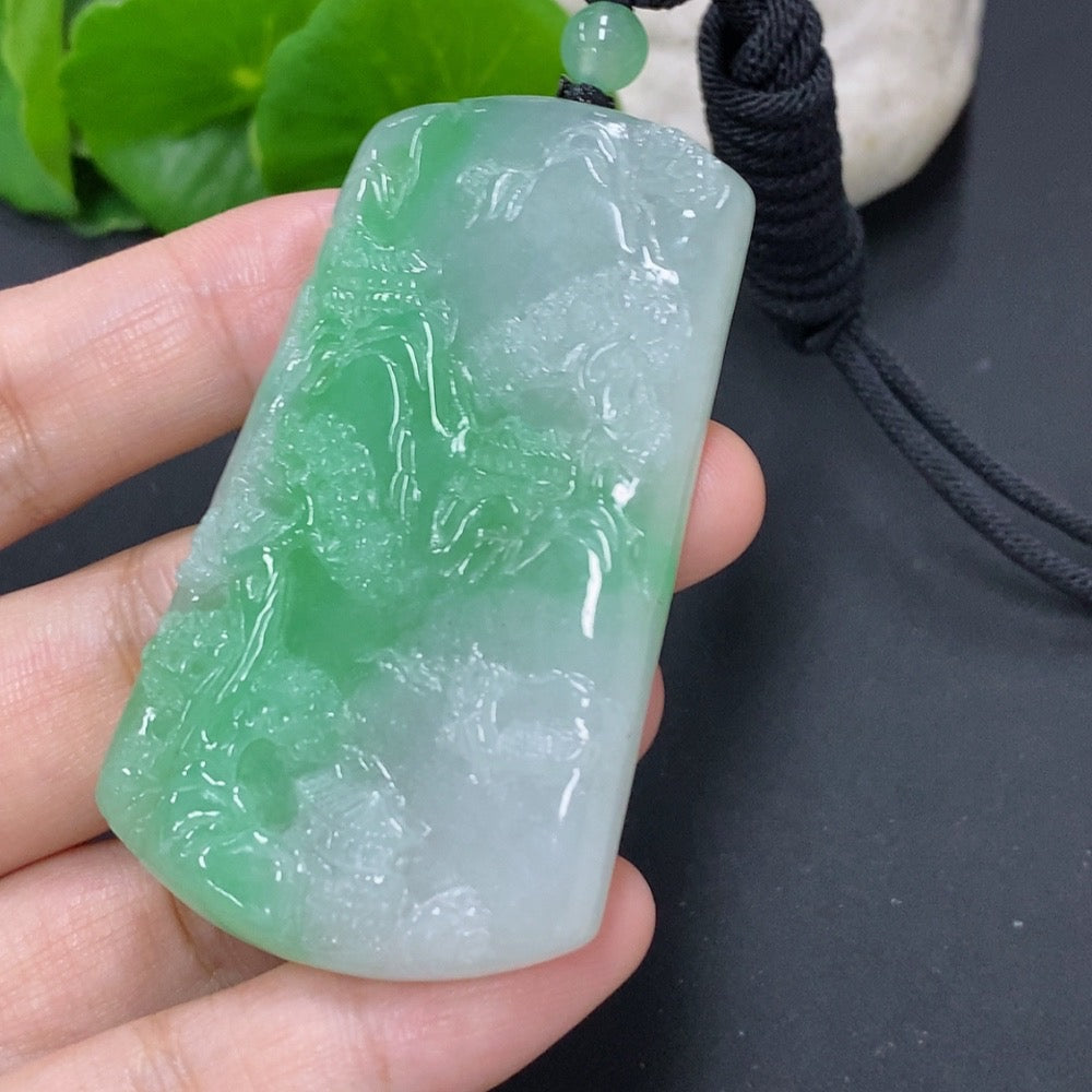 Jadeite pendant with landscape design from HKHQ, weighing approx. 36.4g, featuring a cord for wearing.