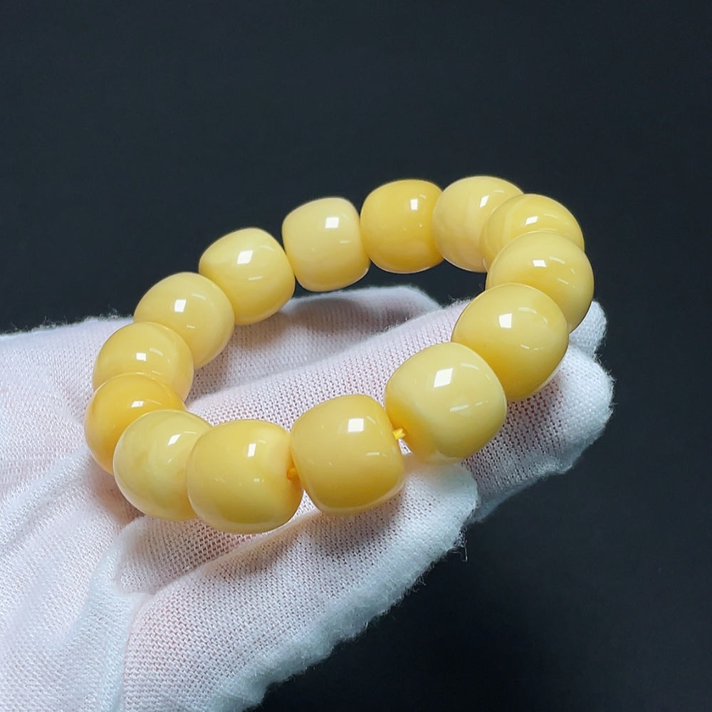 HKHQ amber beeswax bracelet with 13.8mm beads, weighing approximately 22.64g, showcasing warm amber tones and handcrafted design.