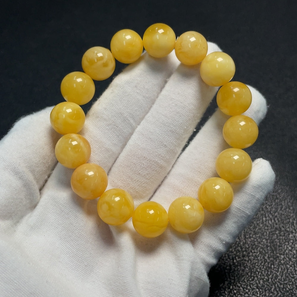 Amber beeswax bracelet with partial visible repairs, total weight approximately 18.25g, size about 12.6mm