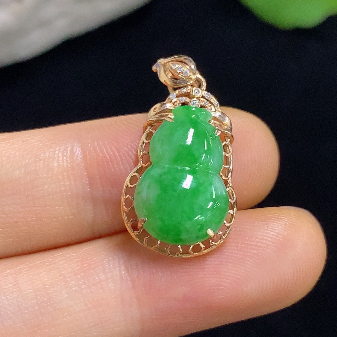 Jadeite gourd pendant by HKHQ with 18k gold inlay and diamond accents, approximately 1.93g, showcasing intricate craftsmanship.