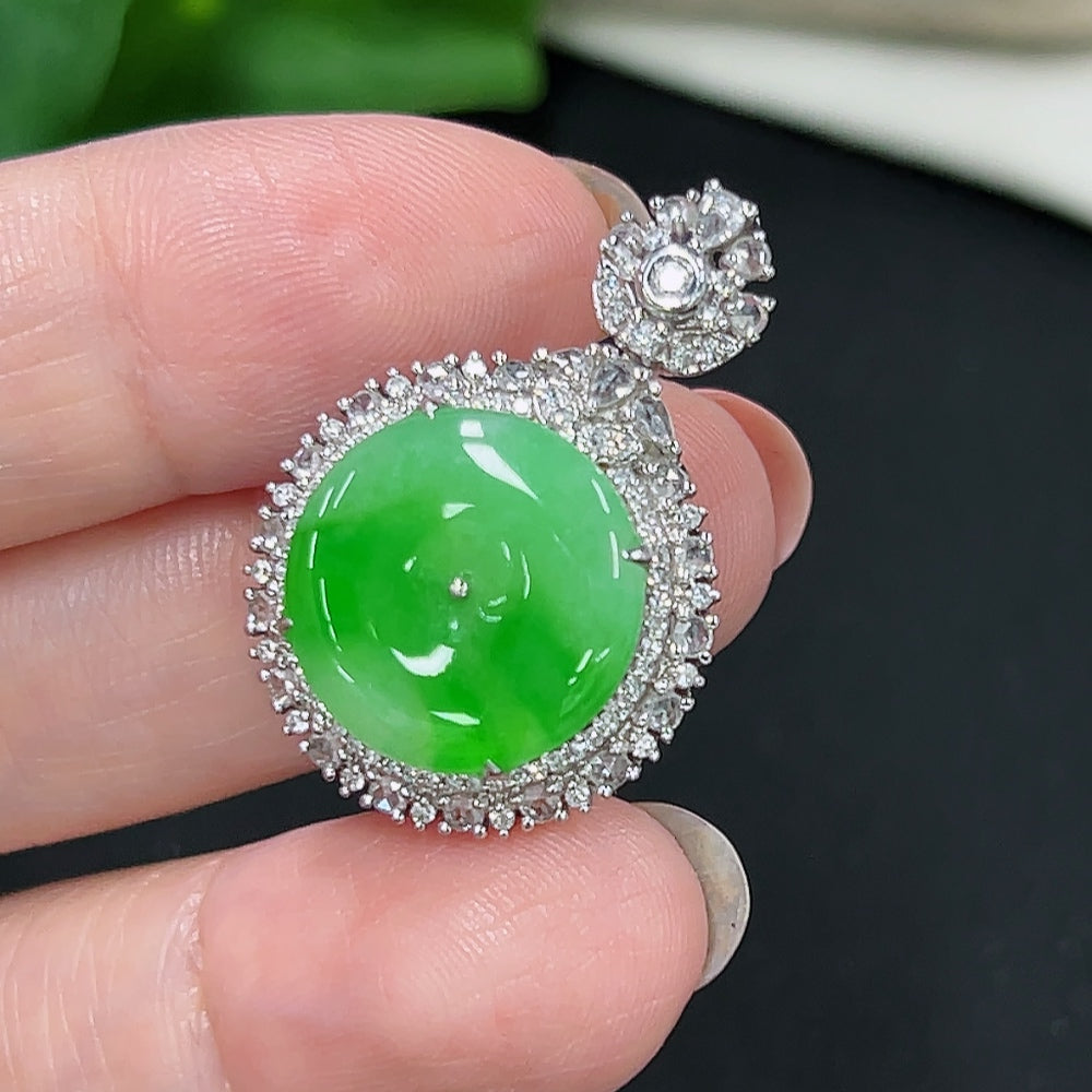 Jadeite pendant with 18K gold setting and diamond accents, showcasing a smooth, polished jade gemstone on a delicate chain.