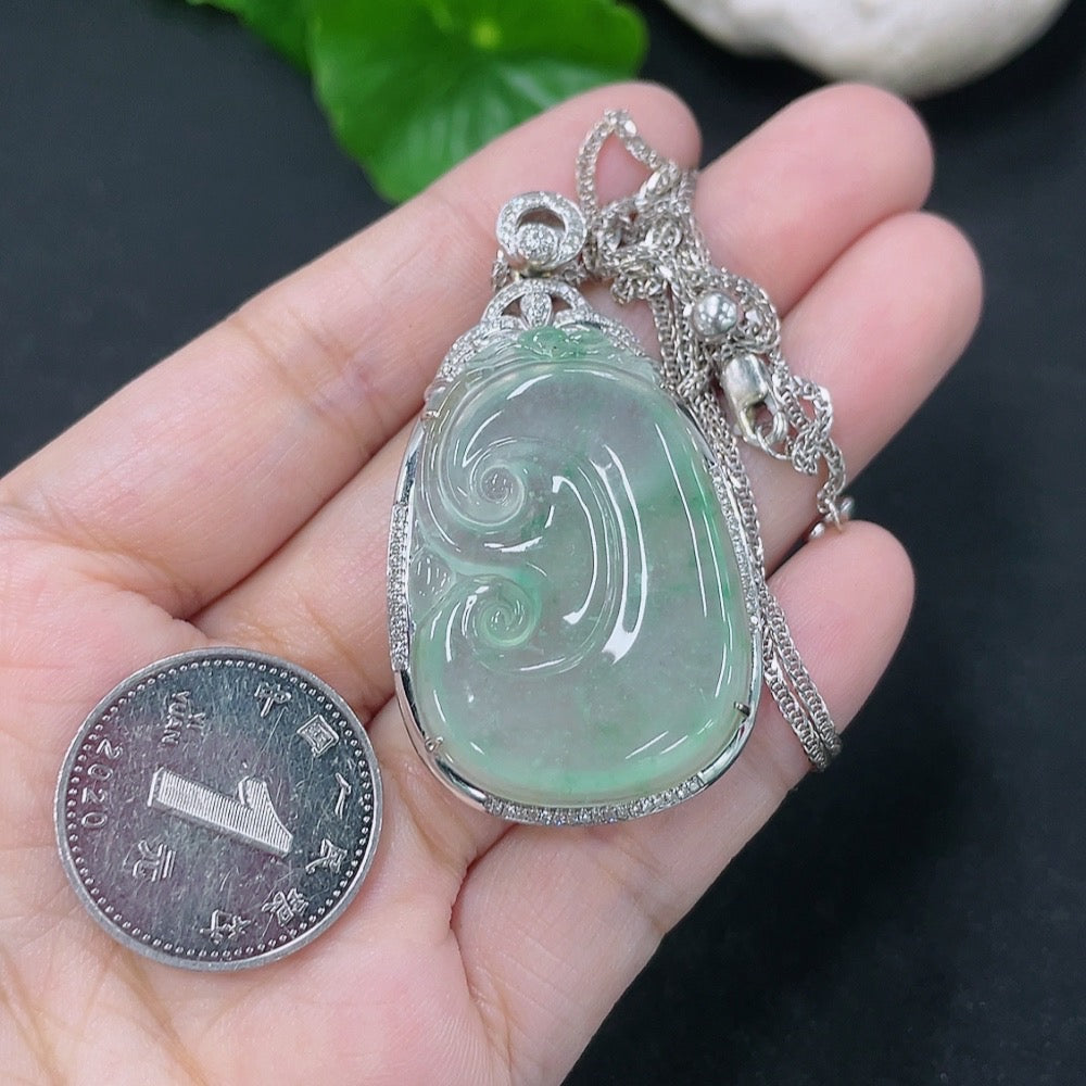 Jadeite inlaid Ruyi pendant with 18K gold accents and diamonds, showcasing intricate craftsmanship and a sleek chain design.
