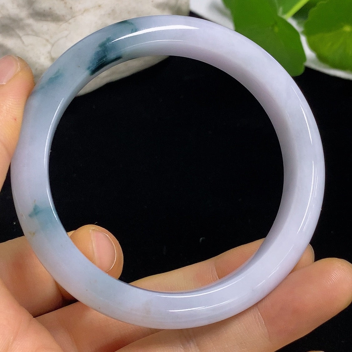 Jadeite round bangle with size 57.6 and weight 54.77g, showcasing smooth, polished jade surface and craftsmanship.