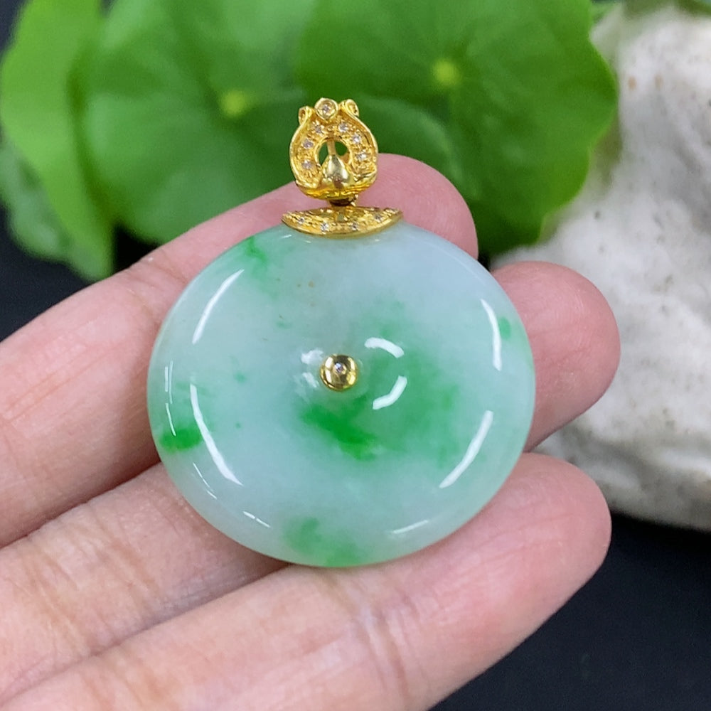 Jadeite Peace Knot pendant with 18K gold clasp and diamond accents, showcasing intricate design and polished jade surface.