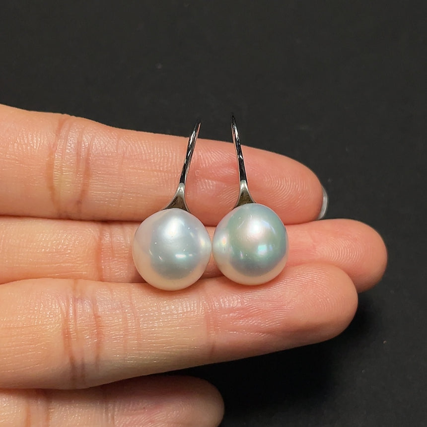 Saltwater pearl earrings in 95% platinum by HKHQ, featuring elegant white pearls and sleek platinum setting.