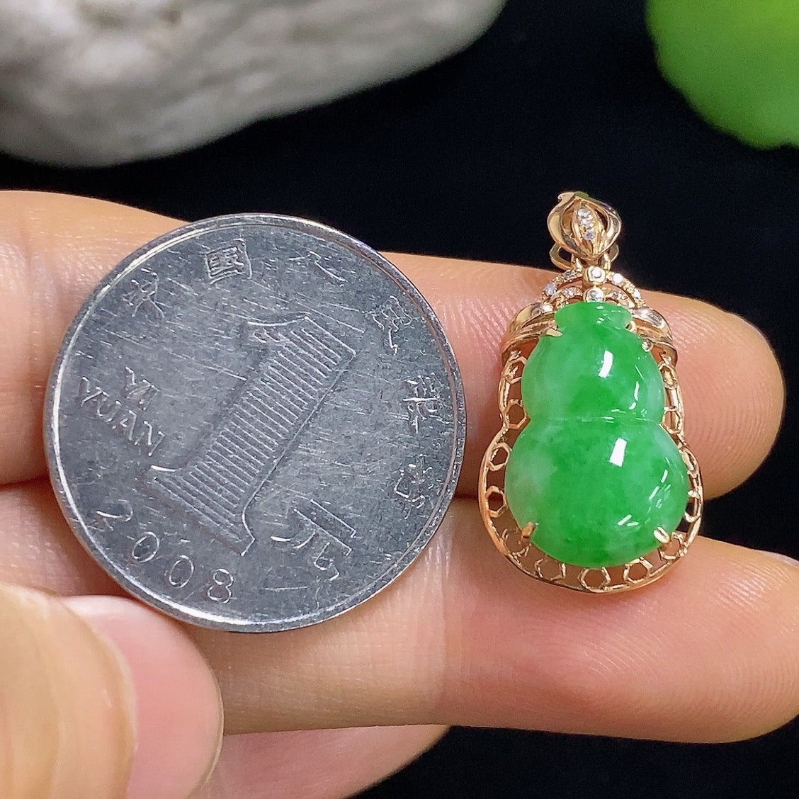 Jadeite gourd pendant with 18k gold inlay and diamond accents, weighing approximately 1.93g, featuring intricate craftsmanship.