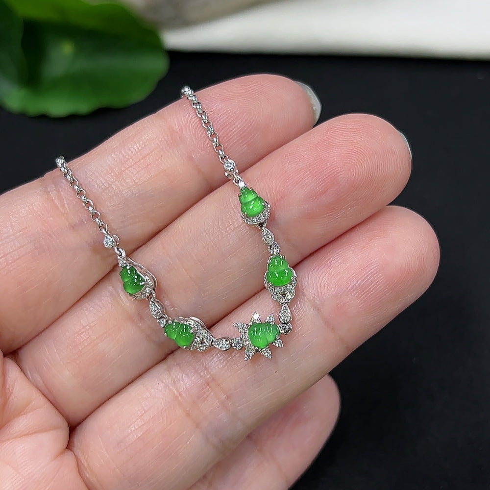 Jadeite gourd inlaid bracelet by HKHQ with 18k gold and diamond accents, showcasing intricate craftsmanship and smooth jade surface.