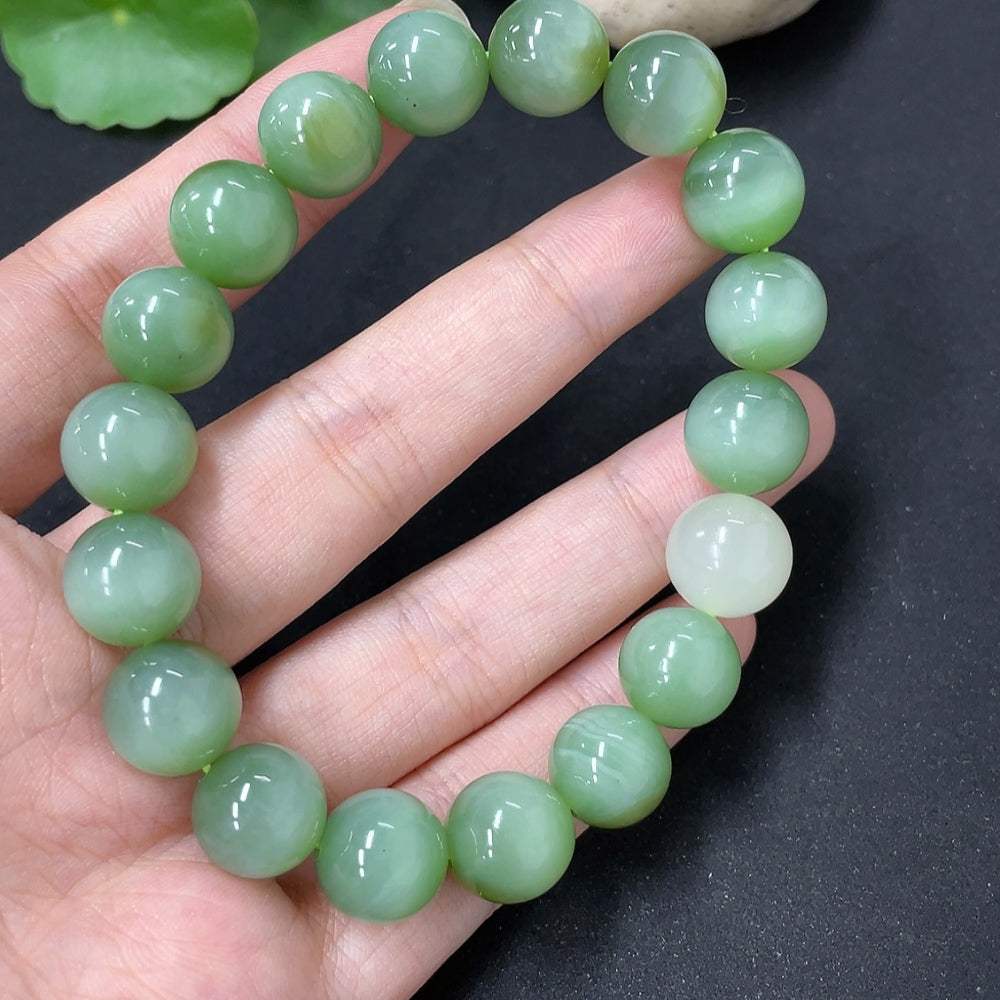 Hetian Jade bracelet with round bead strands, featuring smooth, polished jade stones in natural green hues.