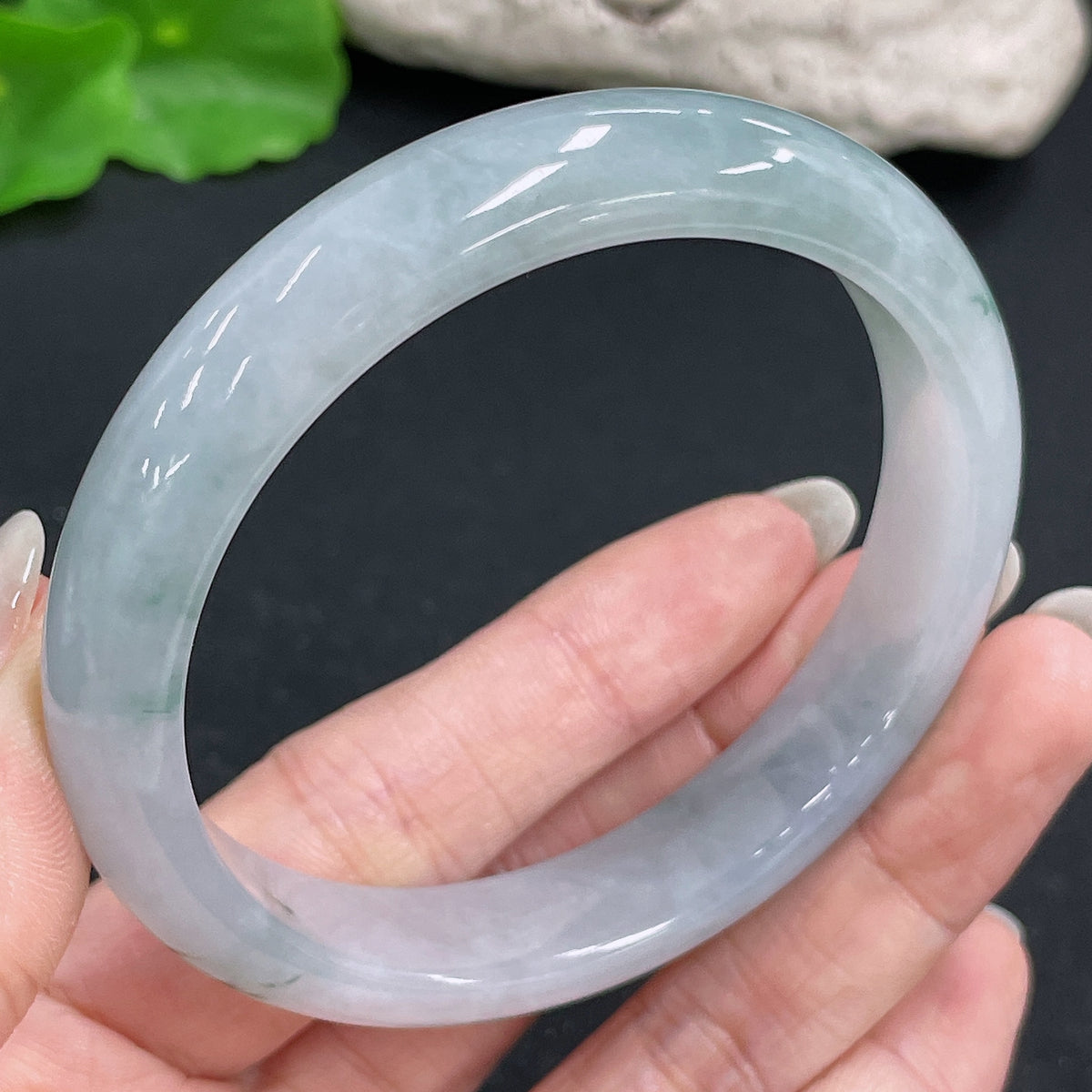 HKHQ jadeite round bangle, size 59.3 with a weight of 51.46g, showcasing smooth, polished green jadeite in a close-up view.