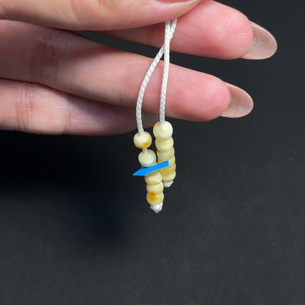Amber beeswax pendant by HKHQ with colorless coating, partial repairs visible, includes collection certificate, weighs approx. 35.77g