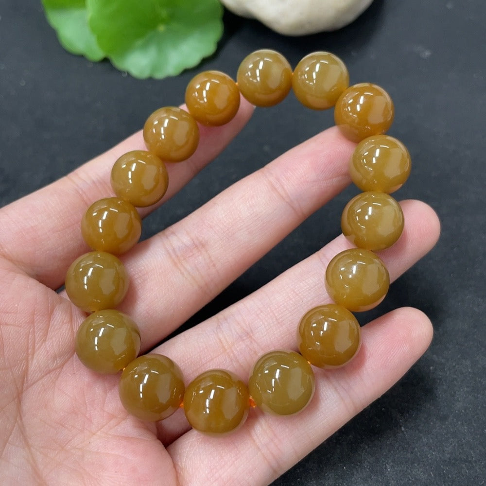 HKHQ Hetian Jade bracelet with 11.7mm beads, weighing approximately 42g, showcasing smooth, polished jade stones on a string.