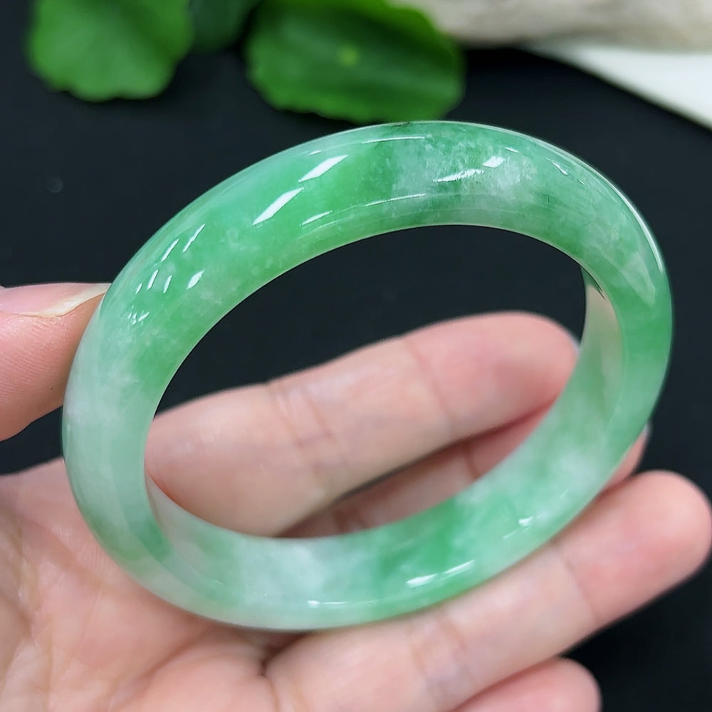 Jadeite round bangle with a 55.1mm diameter, weighing approximately 50.4g, showcasing smooth, polished green jade from HKHQ.