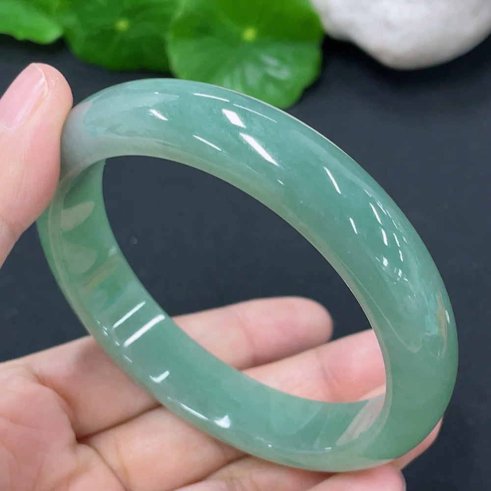 Jadeite round bangle by HKHQ, weighing approx. 54.38g, size 56.9 with smooth, polished jade surface.