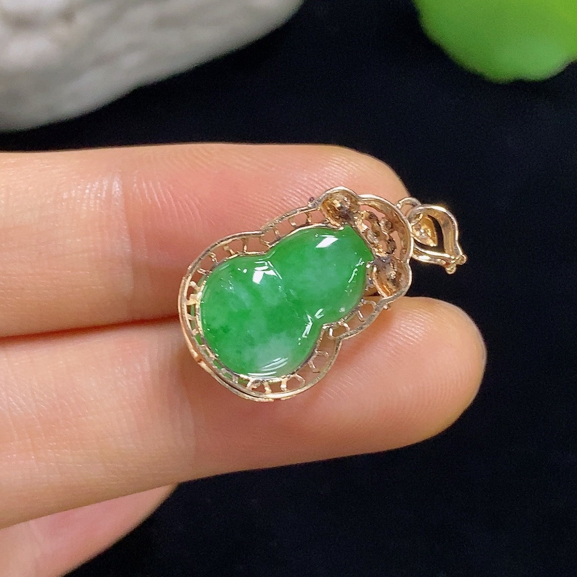 Jadeite gourd pendant with 18k gold inlay and diamond accents, weighing approximately 1.93 grams, by HKHQ.